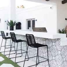 Covered Outdoor Kitchen With Black-And-White Tile Bar
