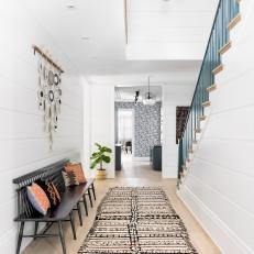 Minimalist Entryway With Bench and Wall Hanging