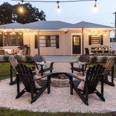 Backyard With Fire Pit, Adirondack Chairs and Bistro Lights