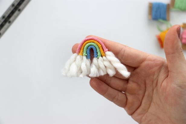 Bend the wrapped yarn into arcs. Use a small amount of hot glue to glue them together into a rainbow.