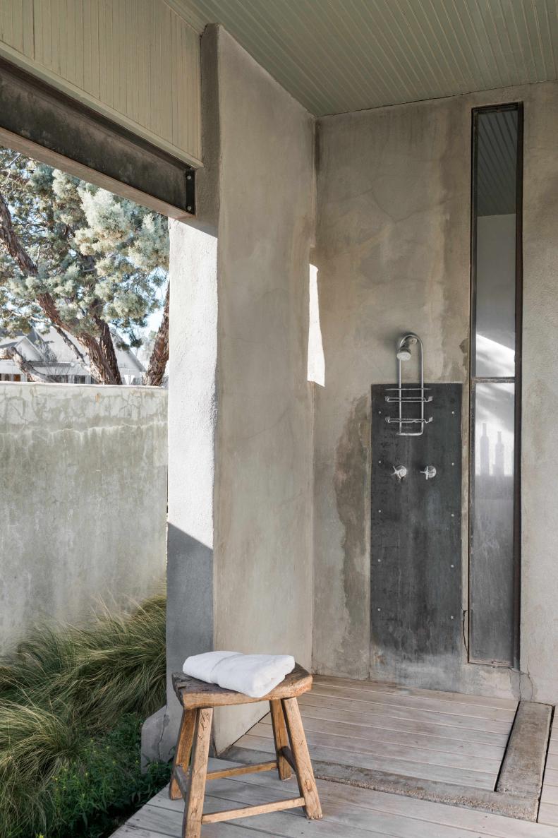 The main house offers guests an incredible showering experience with a privatized outdoor shower along the rear of the property. Industrial in style, the outdoor shower is characterized by a combination of steel, concrete, wood and beadboard cladding.