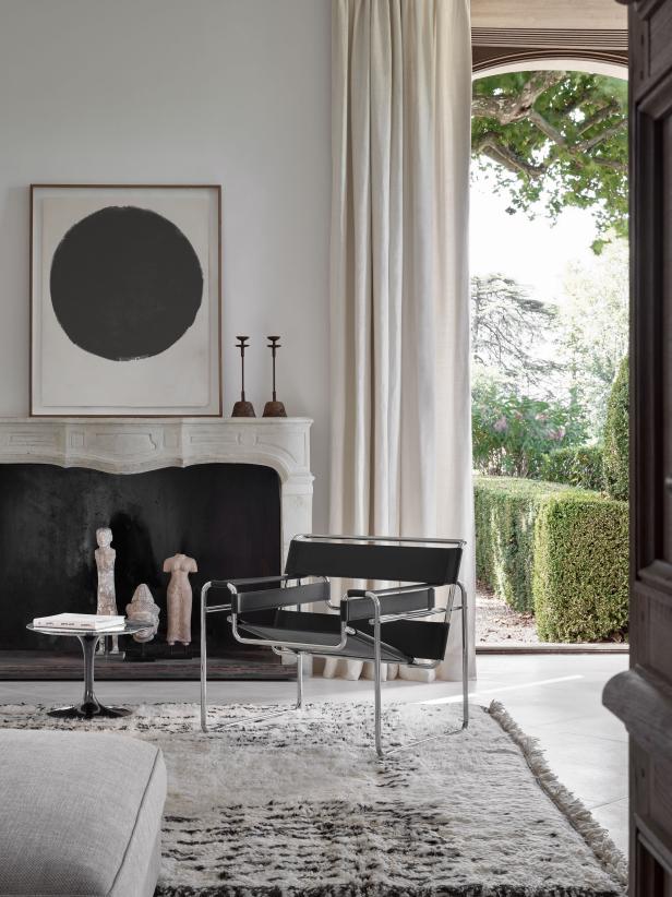 A black-and-white living room features modern and traditional pieces.