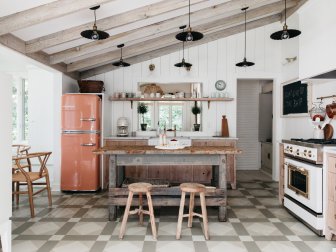 Original cottage had patterned floors and when a wall was removed to open up the floor plan, we had the floors custom painted to match the existing pattern. Fridge is a custom salmon color.  