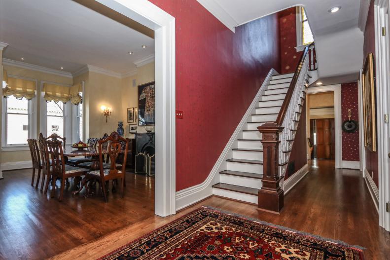 Foyer with Red Walls, Wooden Stairs, Flooring, Access to Dining Room