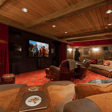 Rustic Home Theater With Red Rug