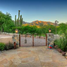 A Stone Walkway Leading Through The Front Gate With A View of the Arizona Mountains