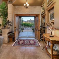 Elegant Foyer in Arizona Home Featuring Painted Brick and Wooden Double Doors