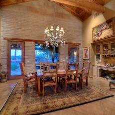 Luxurious Dining Room With Exposed Cedar Ceiling and Matching Cedar Header in Brick Accent Wall