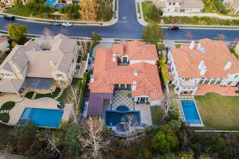 Aerial View of Mediterranean-Style Home With Terra Cotta Roof, Pool