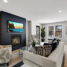 Open Living Room With Natural Lighting and a Black Shiplap Fireplace