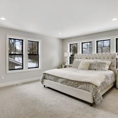 Spacious Carpeted Bedroom With Black Paned Windows