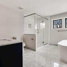 Spacious Bathroom Featuring Freestanding Tub and Glass Shower