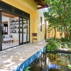 A Tropical Water Feature Is Surrounded by a Flagstone Walkway and Lush Landscaping
