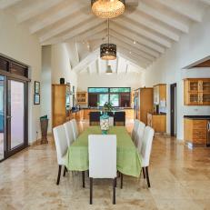 An Open Concept Living Space With Vaulted Ceilings Features a Long Dining Table 