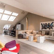 Vaulted Ceilings and Multiple Skylights Accent an Open Concept Living Room 