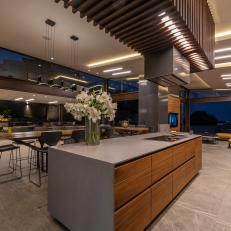 Modern Open Plan Kitchen Features a Large Island With Waterfall Countertop