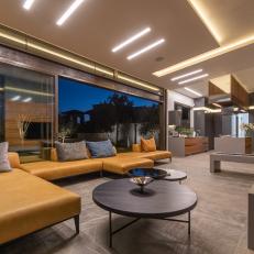 Living Room Features a Leather Sectional and a Wall of Sliding Glass Doors