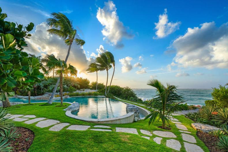 A Large Swimming Pools Features Expansive Oceanfront Views