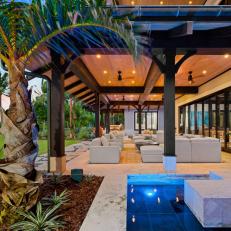 A Small Water Feature Sits Beside a Covered Outdoor Living Area