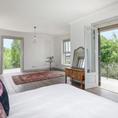 Spacious Bedroom Features a Set of French Doors That Open to a Balcony