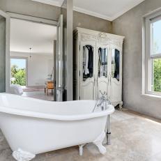 Bathroom With Tile Floors and Textured Walls House a Clawfoot Tub and Wood Armoire 