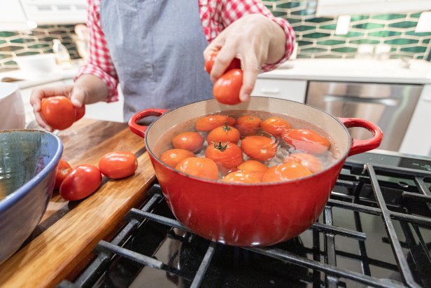 tomatoes in hot water during canning process