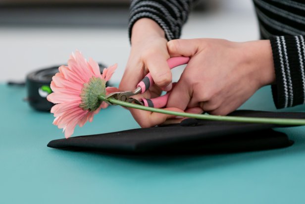 Cut tops of flowers with wire cutters. Tip: Cut as close to the base as possible so it sticks flush to the cap.