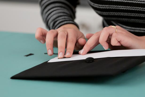 Cut out small black rectangles and glue them on the white piece of paper (to make a road).