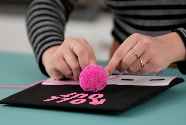 Make a small pom-pom, and attach it to the center of the hat.