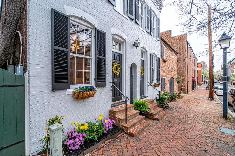 Gray Brick Exterior on Colonial, Semi-Detached Home With Brick Walkway