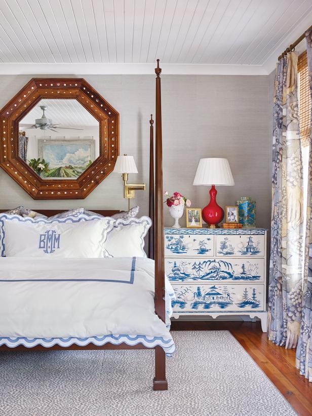 A traditional master bedroom features blue and white textiles.
