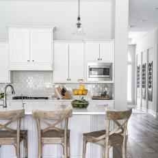 White Open Plan Kitchen With Wood Barstools