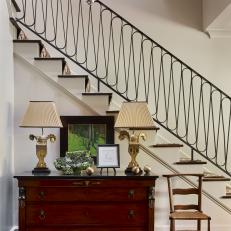 Foyer With Custom Staircase and Antique Chest