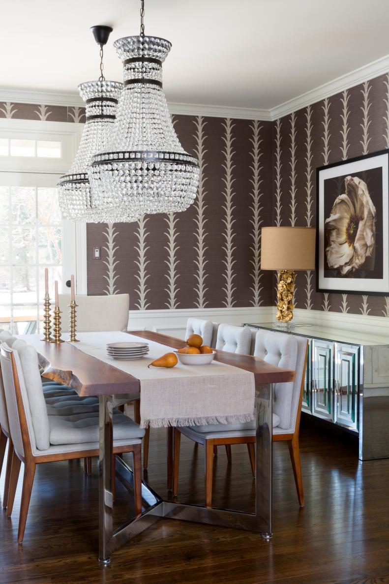 “We really love wallpaper,” Naomi confesses about her firm. This dining room lets her express that love to great effect. As the major source of color and pattern in the space, the wallpaper is the undisputed star of the dining room. “Each room has a distinct personality,” says Naomi. In the dining room, a floral aesthetic reigns. Floral designs are brought in with the wallpaper’s design and are echoed in the artwork and lighting in the dining room. 