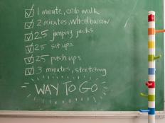 A chalkboard with a list of exercises for kids to perform, similar to Crossfit.