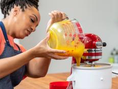 woman pouring mango sorbet in ice cream maker