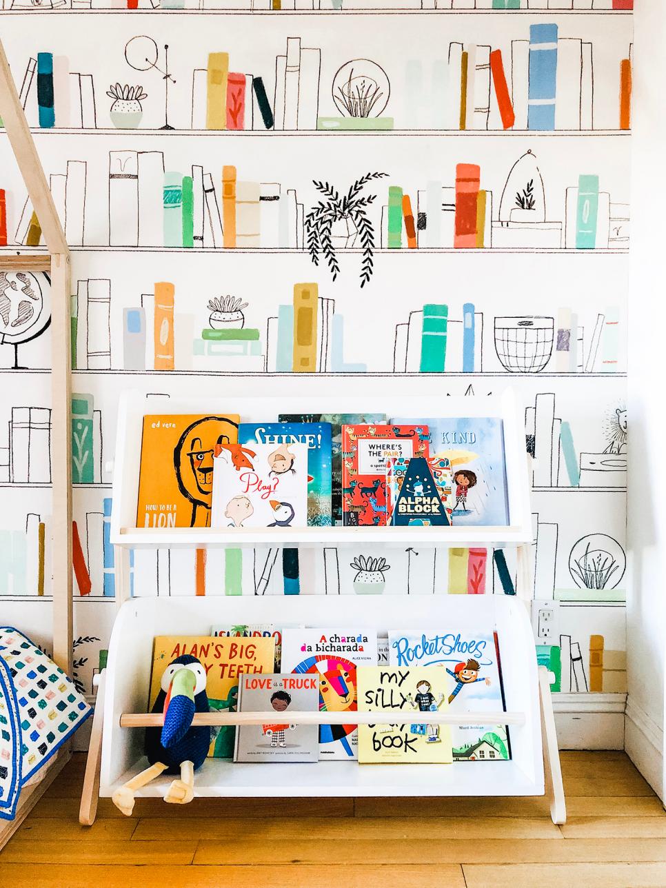 Kid&#039;s Bookcase Against Book-Themed Wallpaper | HGTV