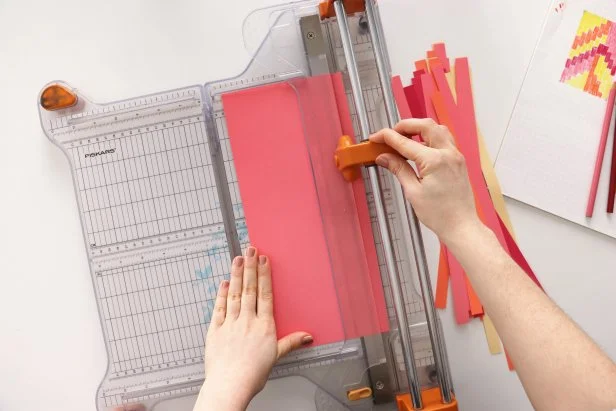 Cut cardstock into ¼” strips using a paper cutter or scissors. Then cut down each strip to pieces that measure 3¼”. Once you have one piece cut, you can use it as a pattern to trim the rest of the strips.