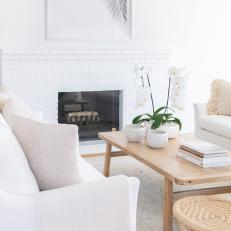 White Scandinavian Living Room With Brick Fireplace