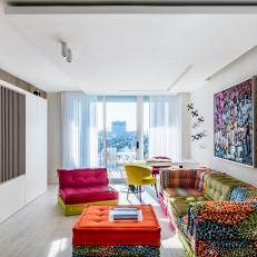 Multicolored Sitting Room With Orange Ottoman