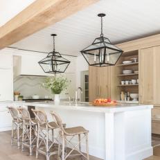 Neutral Kitchen Features a Large Island and Natural Wood Cabinetry 