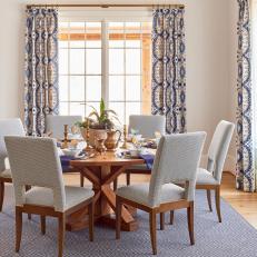 Transitional Dining Room With Blue Curtains