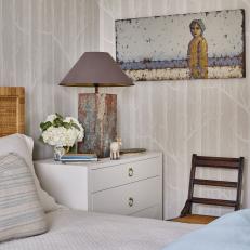 Bedroom With Blue Lamp and Painting.