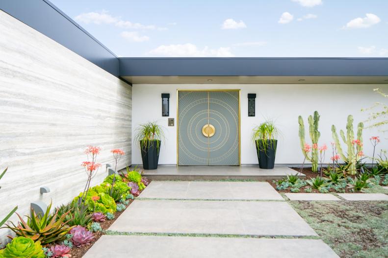 Modern Entrance Features an Inlaid Blue and Gold Front Door
