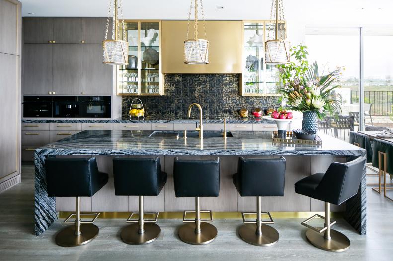 Modern Eat-In Kitchen Features a Marble Island With Leather Barstools