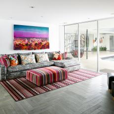 Colorful Sitting Room Features a Wall of Sliding Doors and Bright Accents