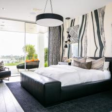 Bold Bedroom Features Black and White Wallpaper and Sliding Glass Doors 