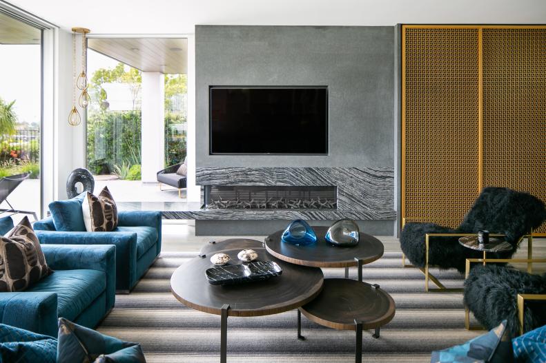 Bright Living Room Features a Cement Fireplace and Modern Furniture