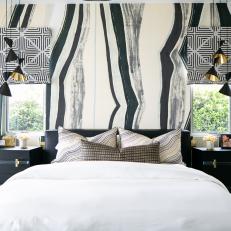 Bold Bedroom Features a Black and White Accent Wall and Modern Pendant Lights