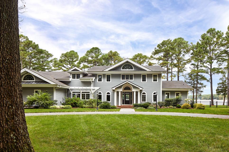 Traditional Home Features Blue Siding and a Circle Driveway